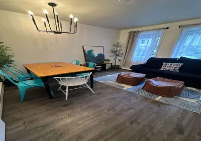 a living room with a table and a couch at Four Bedroom Prime Furnished Rental, June To Aug 90 Days Stay Required in New York