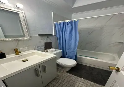 a bathroom with a sink and a toilet and a tub at Four Bedroom Prime Furnished Rental, June To Aug 90 Days Stay Required in New York
