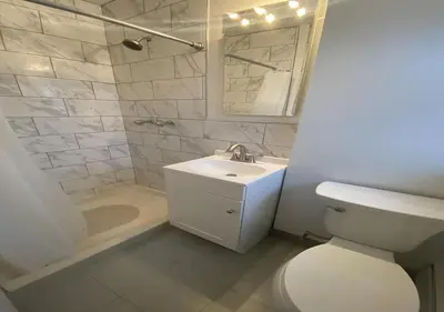 a bathroom with a toilet and a sink and a mirror at Great Location! Spacious 3BR Loft in Midtown West!, June To Aug 90 Days Stay Required in New York