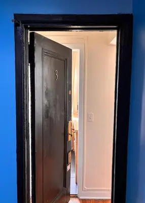 a black door with a mirror in a room at Best Location in Greenwich Village in New York