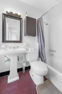 a bathroom with a toilet and a sink and a mirror at Best Location in Greenwich Village in New York