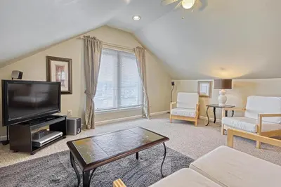 a living room with a tv and a couch at Suites On Chocolate - The Hershey House in Hershey