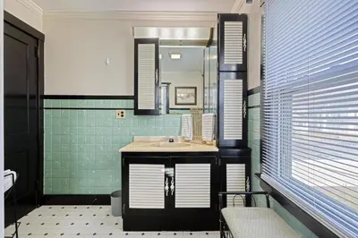 a bathroom with a sink and a mirror at Suites On Chocolate - The Hershey House in Hershey