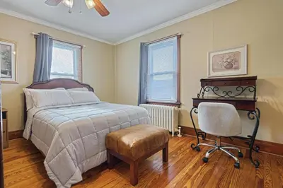 a bedroom with a bed and a chair and a desk at Suites On Chocolate - The Hershey House in Hershey