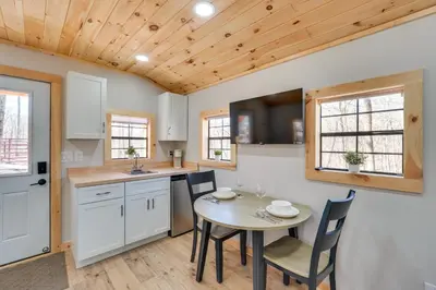a kitchen and dining room with a table and chairs at Close to Trails Studio with Water Views in Wurtsboro