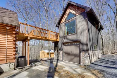 a wooden house with a garage and a deck at Close to Trails Studio with Water Views in Wurtsboro