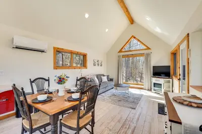 a dining room and living room with a table and chairs at Hike and Fish Outdoor Retreat Near Trails in Wurtsboro