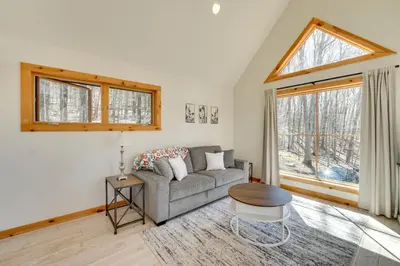 a living room with a couch and a window at Hike and Fish Outdoor Retreat Near Trails in Wurtsboro