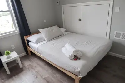 a bedroom with a bed with towels on it at 8BR 4BA Home Near NYC -Sleeps 16 in Irvington