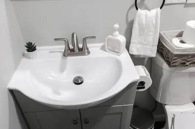 a bathroom with a white sink and a toilet at 8BR 4BA Home Near NYC -Sleeps 16 in Irvington