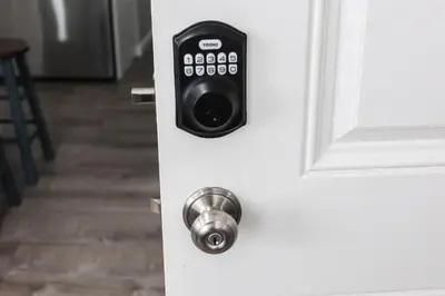a door lock with a remote control on it at 8BR 4BA Home Near NYC -Sleeps 16 in Irvington