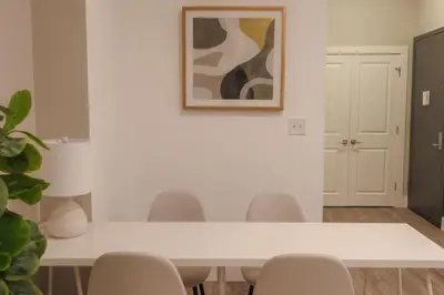 a dining room with a white table and chairs at Private Studio 5 minutes to the NYC train in Bayonne