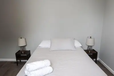 a bedroom with a bed with towels on it at 3Bed 2Bath Apt Near NYC plus Parking and Laundry in Irvington