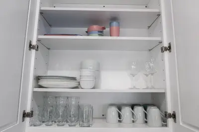 a cupboard filled with glasses and plates and dishes at 3Bed 2Bath Apt Near NYC plus Parking and Laundry in Irvington