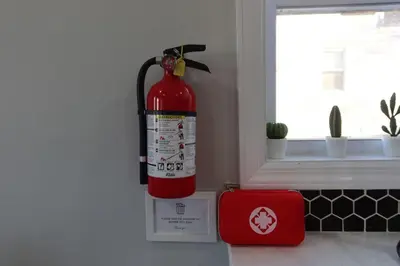 a fire extinguisher hanging on the wall of a kitchen at 3Bed 2Bath Apt Near NYC plus Parking and Laundry in Irvington
