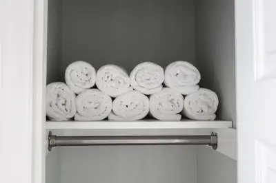 a shelf with a bunch of white towels at 5Bed 2Bath Near NYC, Parking, Laundry in Irvington