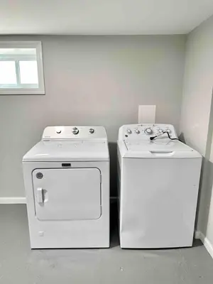 two white appliances sitting next to each other in a room at 5Bed 2Bath Near NYC, Parking, Laundry in Irvington