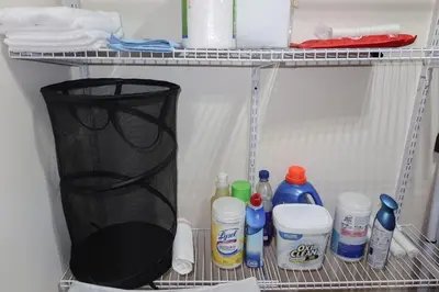 a refrigerator filled with bottles of water and other items at 1Bed 1Bath Apt near EWR, Parking 18 min from Penn St. in Newark