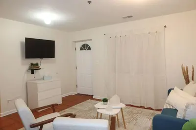a living room with a couch and a tv at 1Bed 1Bath Apt near EWR, Parking 18 min from Penn St. in Newark