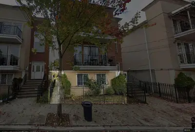 a building with a tree in front of it at 1Bed 1Bath Apt near EWR, Parking 18 min from Penn St. in Newark