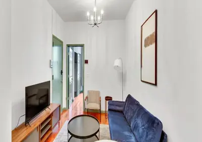 a living room with a couch and a television at Charming 3BR Apartment in NYC in New York