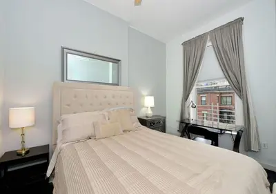 a bedroom with a bed and a window with a piano at 1BR GEM! Close to Central Park!, June To Aug 90 Days Stay Required in New York