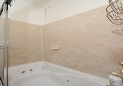 a bathroom with a shower and a bath tub at 1BR GEM! Close to Central Park!, June To Aug 90 Days Stay Required in New York