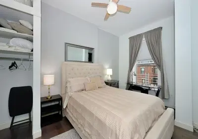 a bedroom with a bed with a ceiling fan and a window at 1BR GEM! Close to Central Park!, June To Aug 90 Days Stay Required in New York