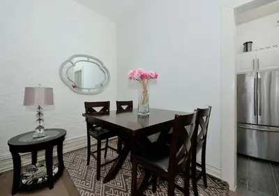a dining room table with chairs and a vase of flowers at 1BR GEM! Close to Central Park!, June To Aug 90 Days Stay Required in New York