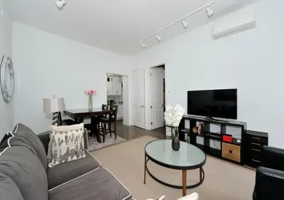 a living room with a couch and a table at 1BR GEM! Close to Central Park!, June To Aug 90 Days Stay Required in New York