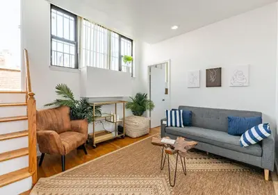 a living room with a couch and a chair at Amazing Furnished 1 BR Midtown West in New York