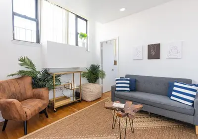 a living room with a couch and a chair at Amazing Furnished 1 BR Midtown West in New York