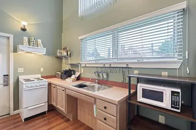 a kitchen with a sink and a microwave at Suites On Chocolate - The School in Hershey