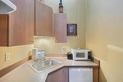 a small kitchen with a sink and a microwave at Suites On Chocolate - The Theater in Hershey