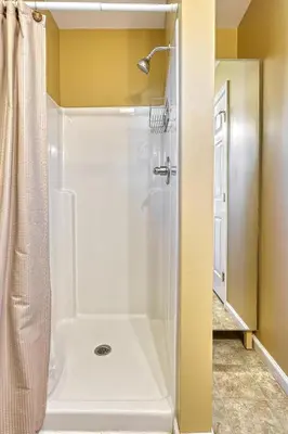 a bathroom with a shower with a shower curtain at Suites On Chocolate - The Theater in Hershey