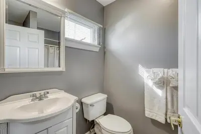 a bathroom with a white toilet and a sink at Suites On Chocolate - The Factory in Hershey