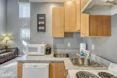 a kitchen with a sink and a microwave at Suites On Chocolate - The Factory in Hershey