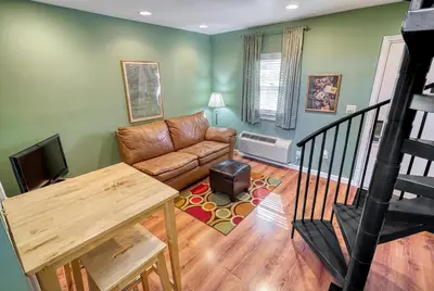 a living room with a couch and a table at Suites On Chocolate - The Club in Hershey