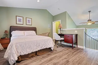 a bedroom with a bed and a desk at Suites On Chocolate - The Zoo in Hershey