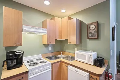 a kitchen with a sink and a microwave at Suites On Chocolate - The Zoo in Hershey