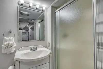 a bathroom with a sink and a shower at Suites On Chocolate - The Studio in Hershey