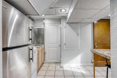a kitchen with a white door and a sink at Suites On Chocolate - The Studio in Hershey