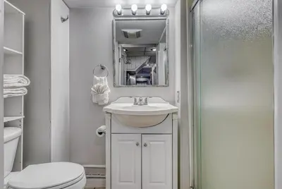 a bathroom with a sink and a toilet and a mirror at Suites On Chocolate - The Studio in Hershey