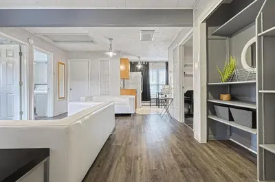 a kitchen and living room with a couch and a table at Suites On Chocolate - The Annville Cottage in Annville