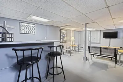 a bar in a room with chairs and tables at Suites On Chocolate - The Annville Cottage in Annville