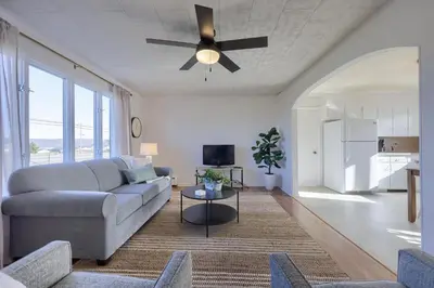 a living room with a couch and a ceiling fan at Mountain Sunrise Retreat in Klingerstown
