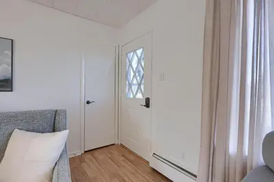 a living room with a door and a window at Mountain Sunrise Retreat in Klingerstown