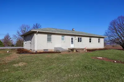 a white house with a picnic table in a yard at Mountain Sunrise Retreat in Klingerstown