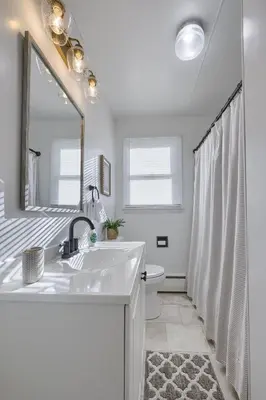 a bathroom with a sink and a toilet and a mirror at Mountain Sunrise Retreat in Klingerstown