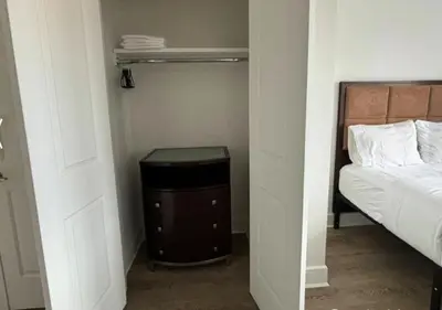 a small bedroom with a bed and a small table at Close to Times Square! Stunning Studio in NYC! in New York